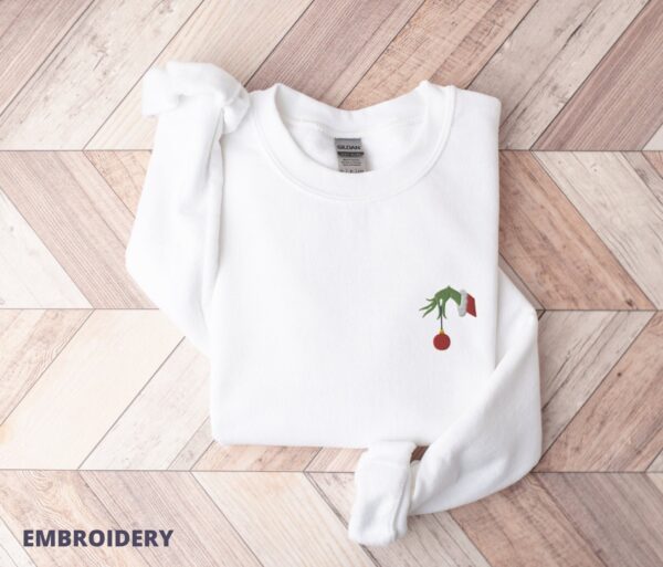 Grinch Hand Holding Ornament Embroidered The Left Chest Sweatshirt